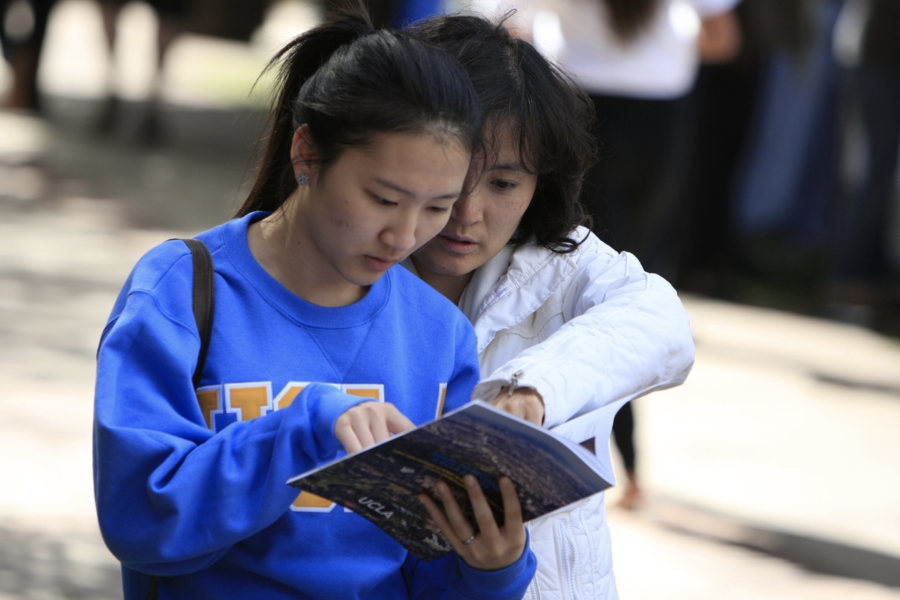 A newly-admitted freshman consults the Bruin Day 2012 program for her next activity.
